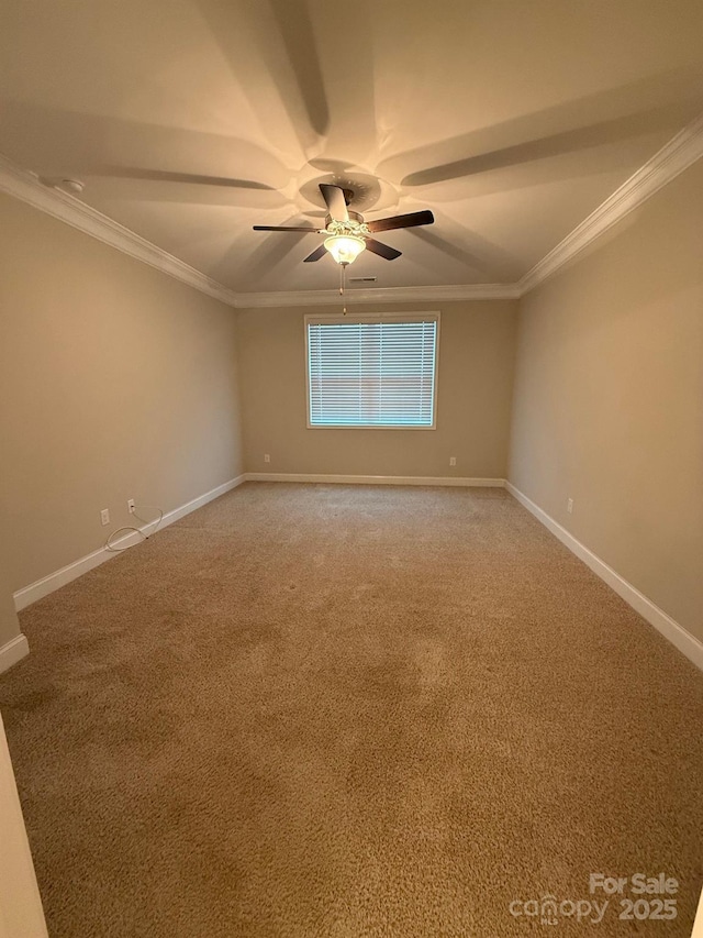 spare room featuring light carpet, ornamental molding, and baseboards