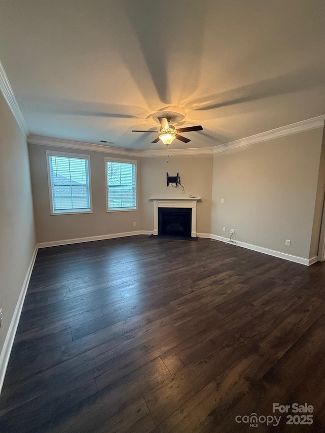 unfurnished living room featuring ornamental molding, baseboards, dark wood finished floors, and a fireplace with flush hearth