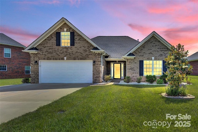 view of front of property with driveway, a front lawn, roof with shingles, and brick siding