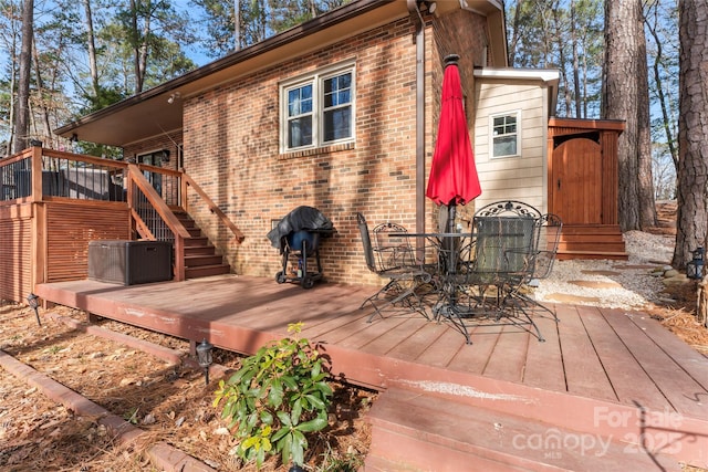 wooden deck featuring outdoor dining area