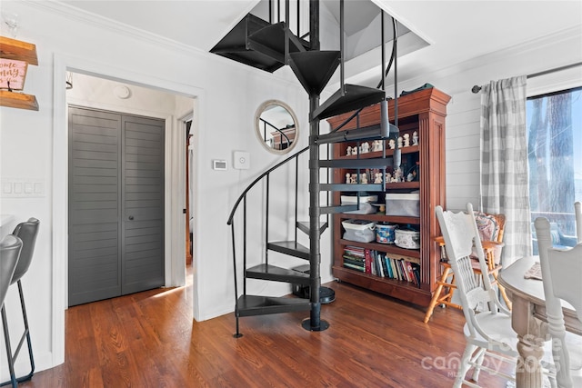 stairs featuring ornamental molding and wood finished floors