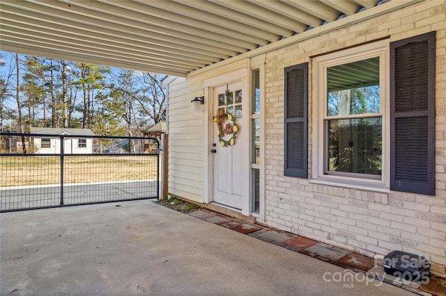 doorway to property with brick siding