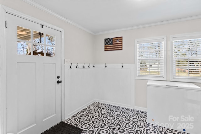 doorway to outside featuring light tile patterned floors and ornamental molding