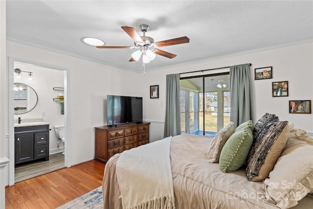 bedroom with connected bathroom, light wood-style flooring, ceiling fan, ornamental molding, and access to exterior