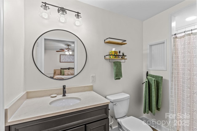 ensuite bathroom with ensuite bathroom, vanity, toilet, and a ceiling fan