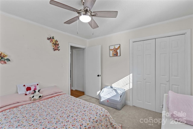 bedroom with ornamental molding, a closet, and light colored carpet