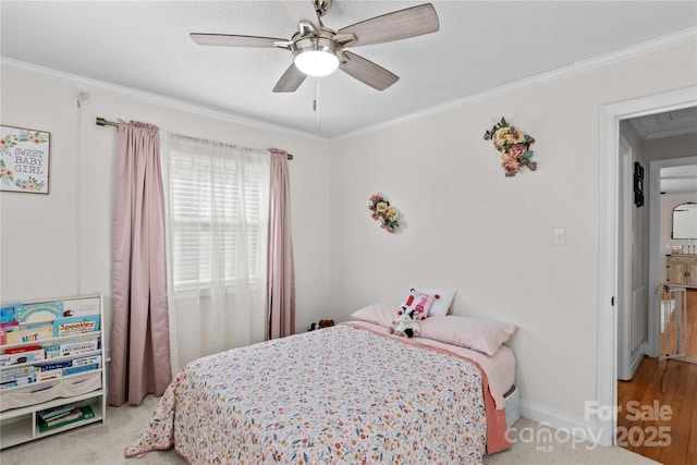 bedroom featuring a ceiling fan, crown molding, and baseboards