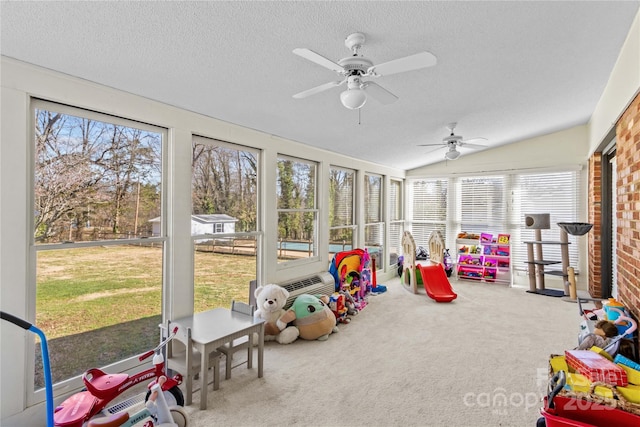 sunroom with vaulted ceiling and a ceiling fan