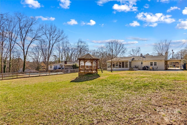 view of yard with a gazebo and fence