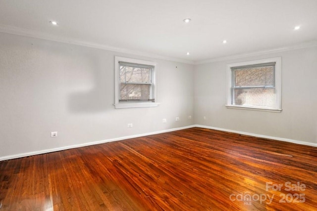 spare room with ornamental molding, recessed lighting, wood finished floors, and baseboards