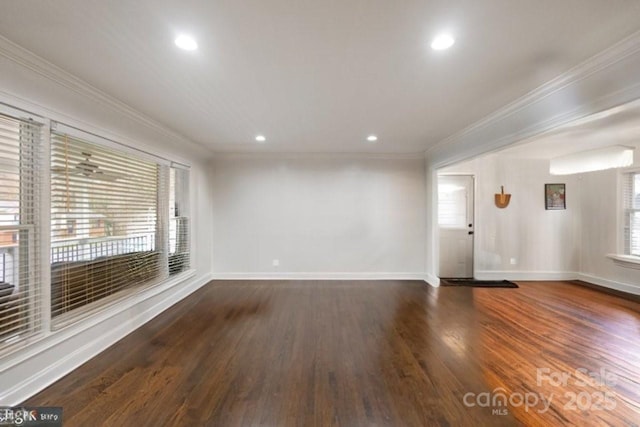 empty room with ornamental molding, recessed lighting, baseboards, and wood finished floors