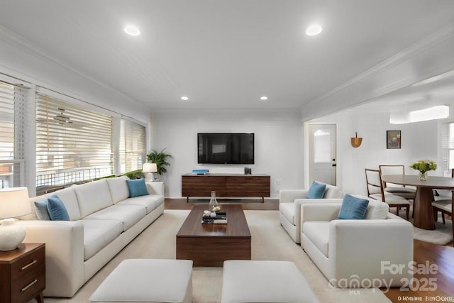 living area with light wood-style floors, recessed lighting, and crown molding