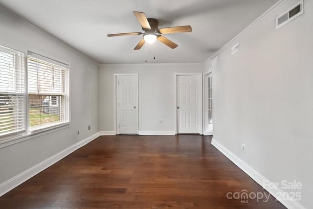 unfurnished bedroom featuring ceiling fan, wood finished floors, visible vents, baseboards, and ornamental molding