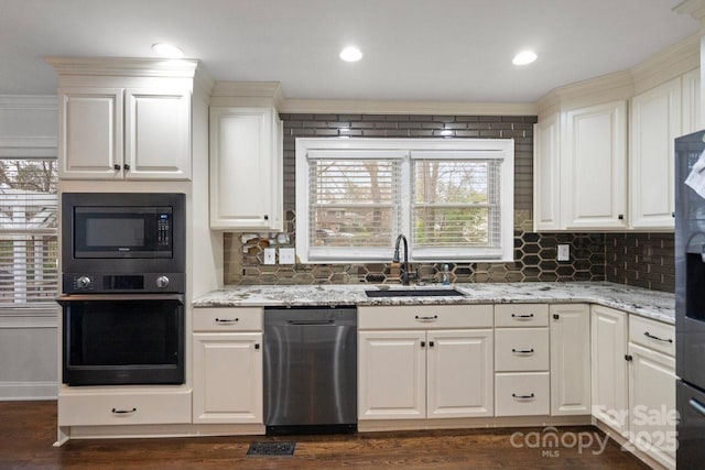 kitchen with oven, a sink, stainless steel dishwasher, built in microwave, and dark wood finished floors