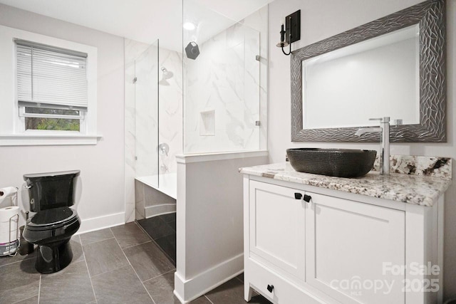 full bathroom featuring a bathtub, a marble finish shower, toilet, vanity, and baseboards