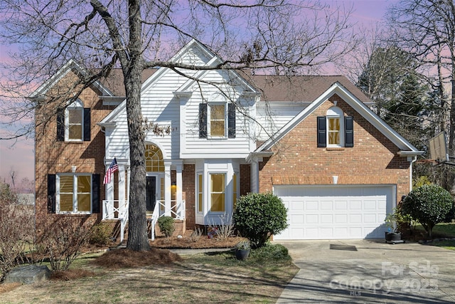 traditional home with concrete driveway, brick siding, and an attached garage