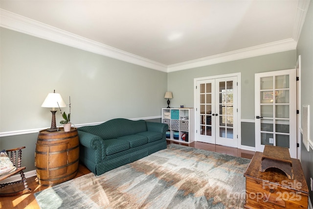 living area featuring ornamental molding, french doors, wood finished floors, and baseboards