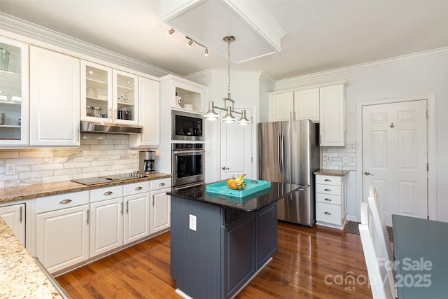 kitchen with white cabinets, under cabinet range hood, stainless steel appliances, and dark wood-type flooring