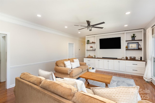 living area with ornamental molding, a ceiling fan, light wood-style flooring, and recessed lighting