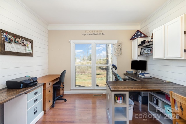 home office with dark wood-style floors and crown molding