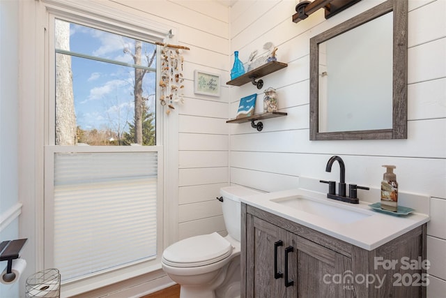 half bathroom with vanity and toilet