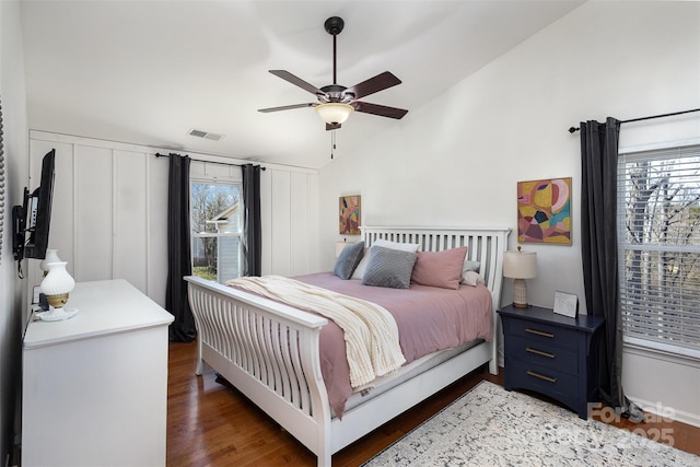 bedroom with lofted ceiling, light wood-style flooring, multiple windows, and visible vents