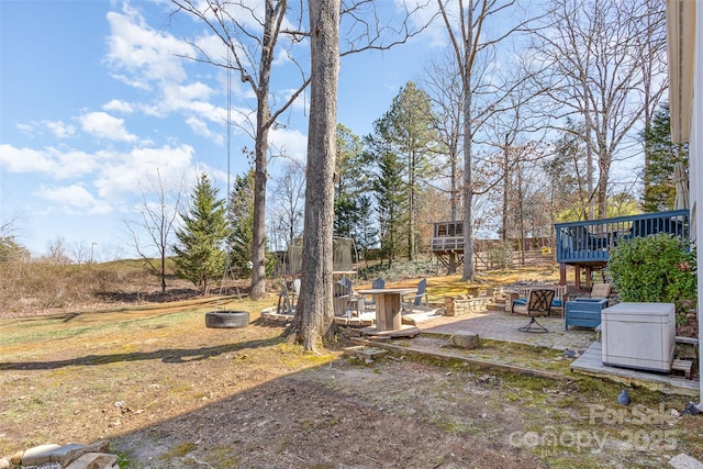 view of yard featuring a patio area and a wooden deck