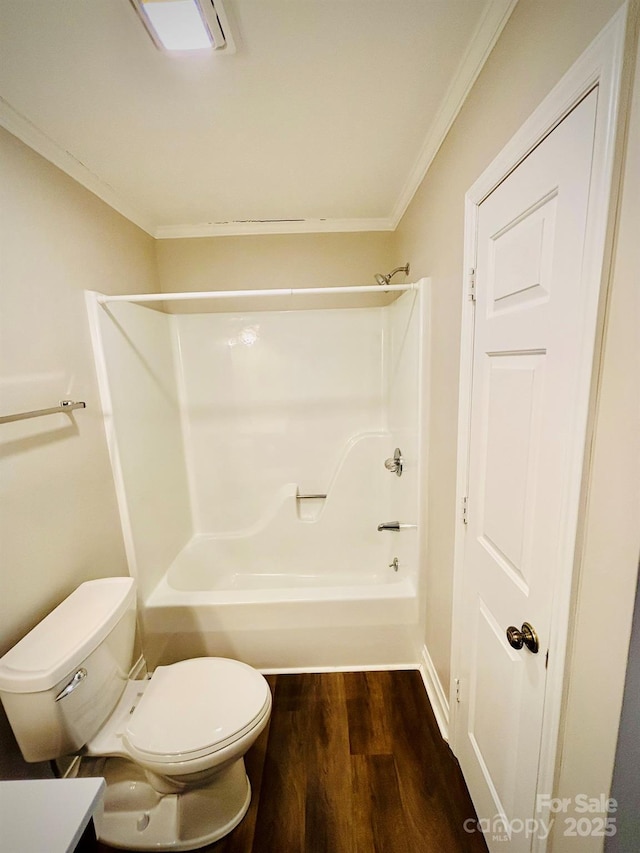 full bath featuring ornamental molding, tub / shower combination, wood finished floors, and toilet