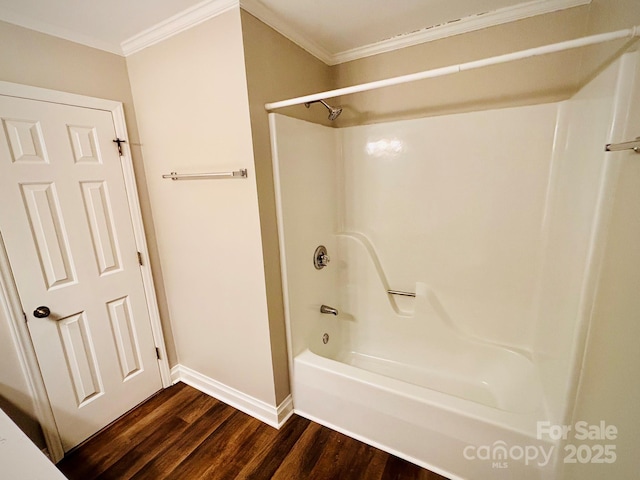 bathroom with  shower combination, baseboards, crown molding, and wood finished floors