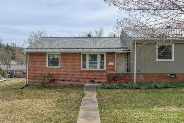 view of front of home with crawl space, metal roof, a front lawn, and brick siding