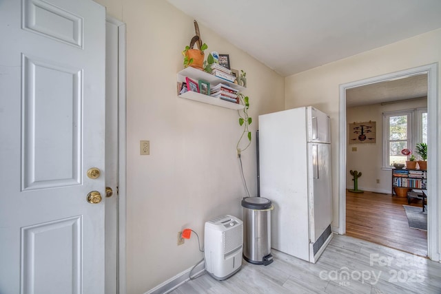 interior space with light wood-style flooring and baseboards