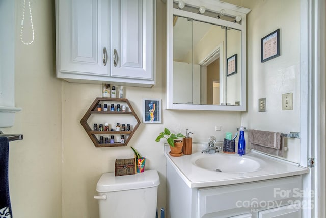 half bathroom with toilet and vanity