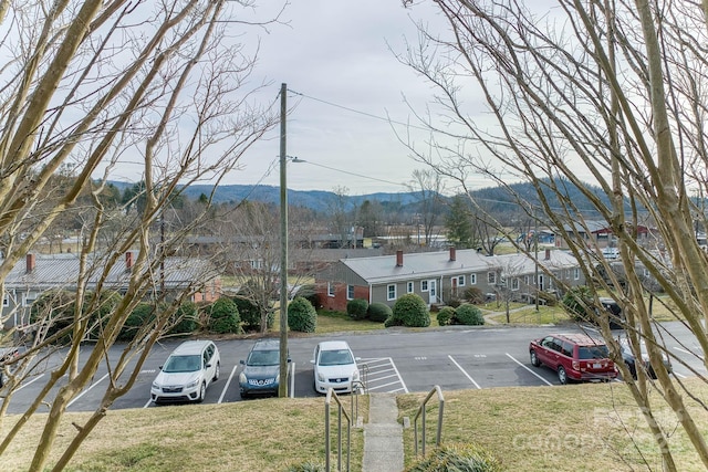 uncovered parking lot with a residential view and a mountain view