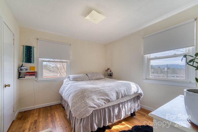 bedroom featuring wood finished floors and baseboards