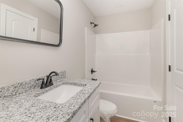 bathroom featuring toilet, washtub / shower combination, and vanity