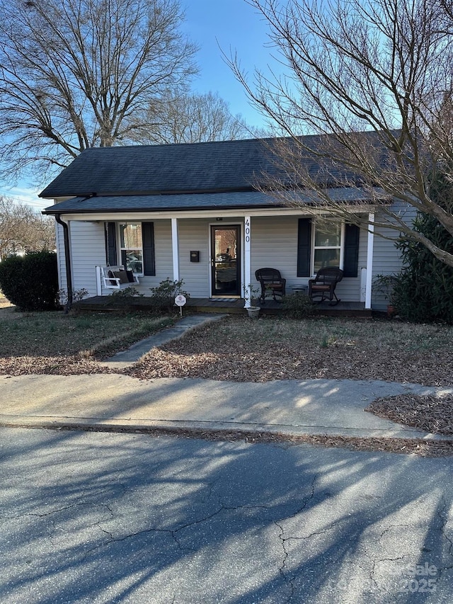 view of front of home with a porch and a shingled roof