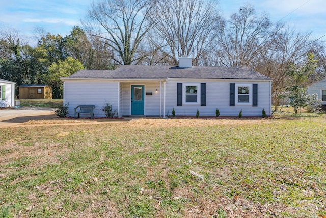 single story home featuring a chimney and a front yard