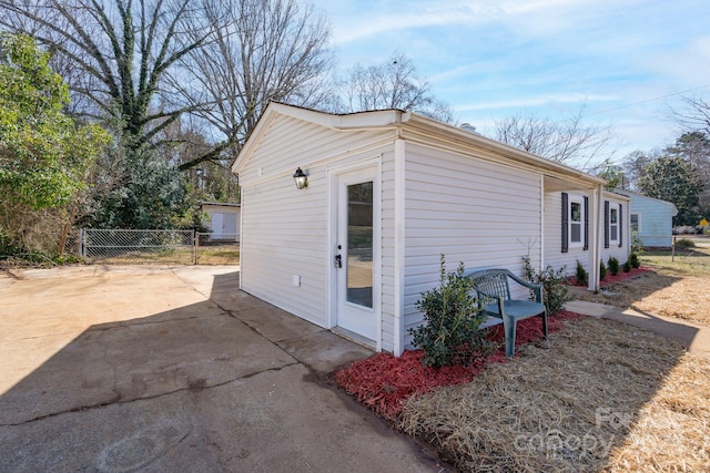 view of side of property featuring a patio area and fence