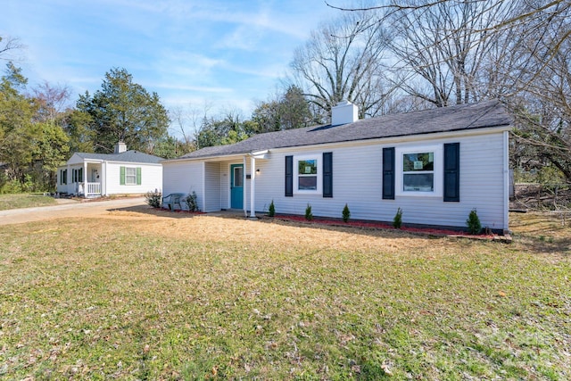 ranch-style home with a front lawn and a chimney