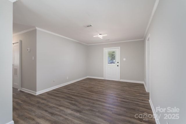 entryway with baseboards, dark wood finished floors, visible vents, and crown molding