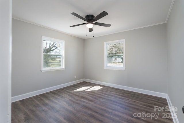 empty room with a ceiling fan, baseboards, dark wood-type flooring, and crown molding