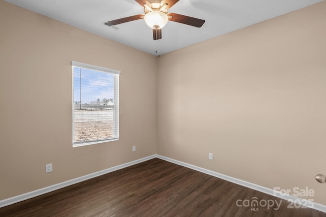 unfurnished room featuring dark wood-style floors, visible vents, baseboards, and ceiling fan