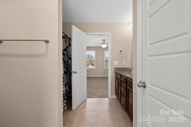 full bathroom featuring tile patterned flooring, vanity, and baseboards