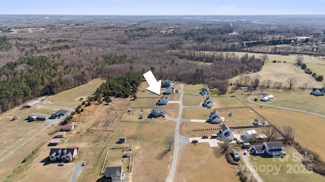 birds eye view of property with a rural view