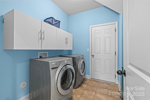 laundry room with cabinet space, baseboards, washer and clothes dryer, and light tile patterned flooring