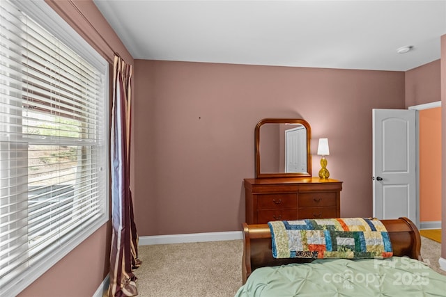 carpeted bedroom featuring baseboards