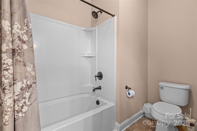 full bath with toilet, shower / bath combo, baseboards, and tile patterned floors