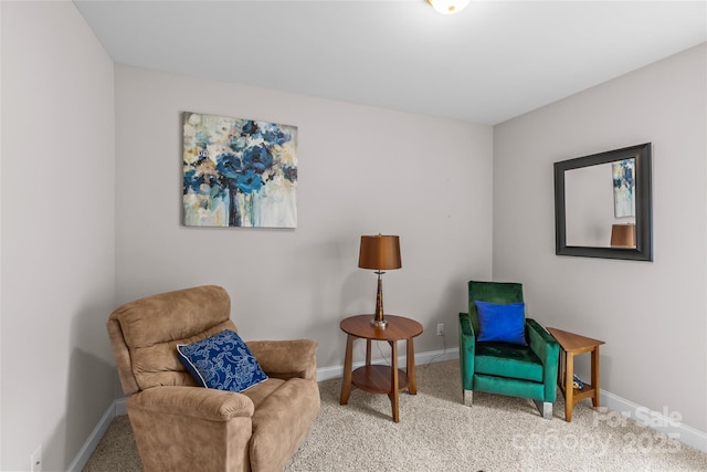 living area featuring carpet floors and baseboards