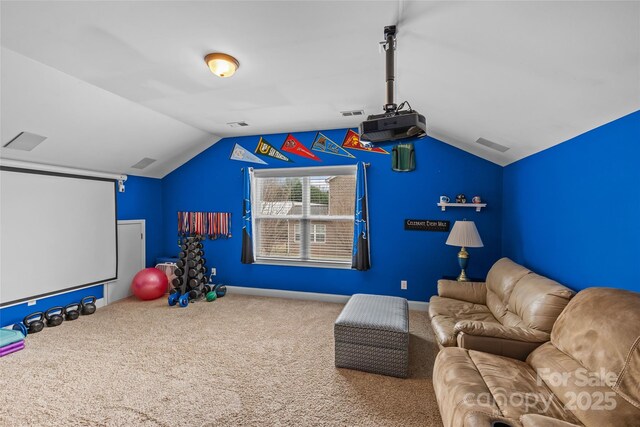 home theater room featuring vaulted ceiling, carpet, visible vents, and baseboards