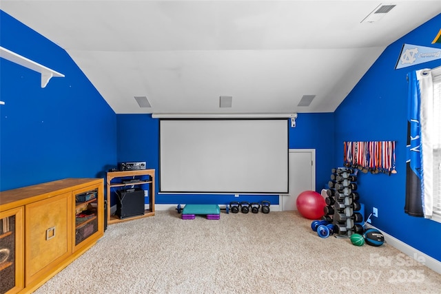 cinema featuring lofted ceiling, baseboards, visible vents, and carpet